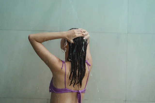 A girl washing her hair before getting a haircut.